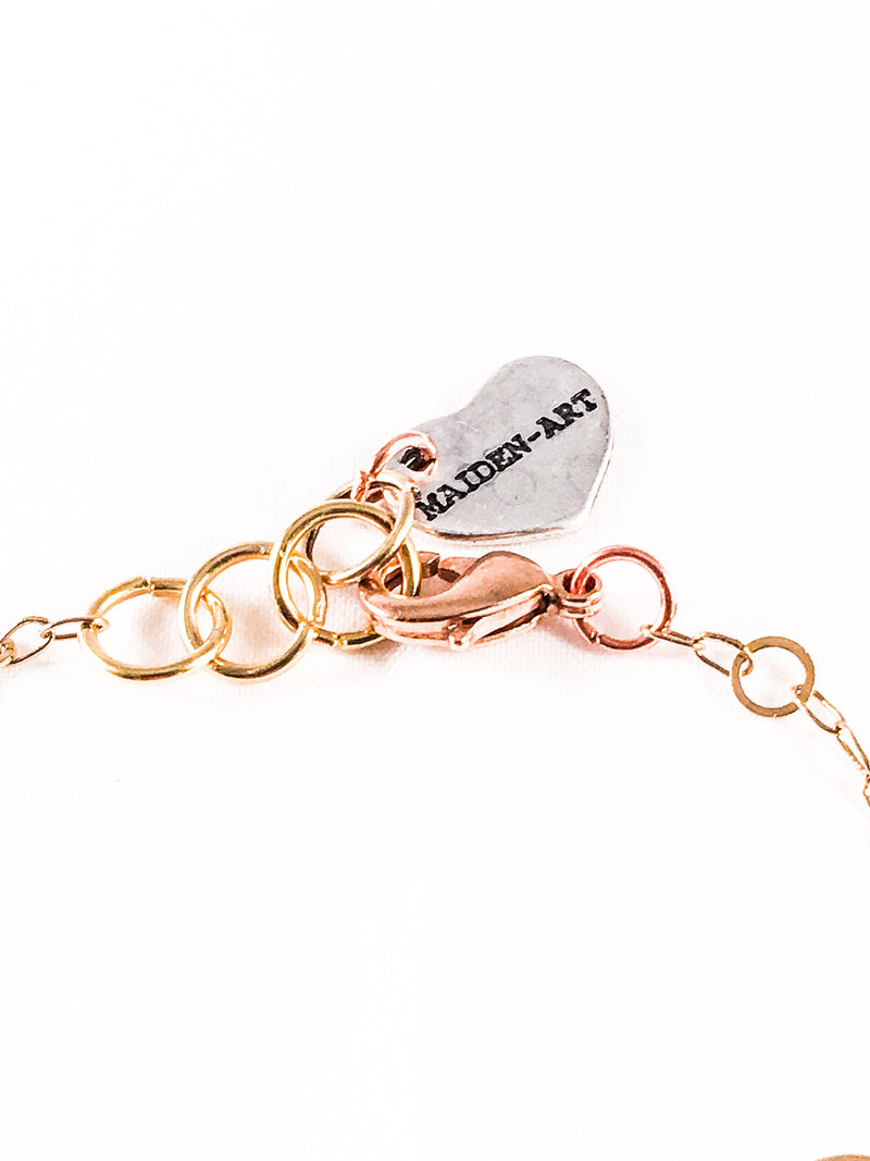 Triple Bronze Heart Charms Bracelet With 18kt Gold Plated Flower Chain.