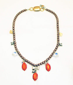 Beaded Necklace With Orange Rhinestones, Silver Plated Brass and Small Charms.